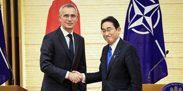 NATO Secretary-General Jens Stoltenberg, left, and Japan's Prime Minister Fumio Kishida shake hands after holding a joint media briefing on Jan. 31, 2023, in Tokyo, Japan. 