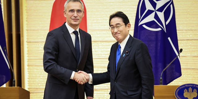 NATO Secretary-General Jens Stoltenberg, left, and Japan's Prime Minister Fumio Kishida shake hands after holding a joint media briefing on Jan. 31, 2023, in Tokyo, Japan.