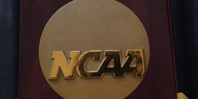 The NCAA logo on the 2023 Division I Men's basketball national championship trophy on display prior to a basketball game between the Maine Black Bears and the Brown Bears Nov. 27, 2022, at Pizzitola Sports Center in Providence, R.I.