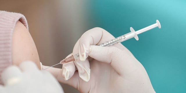 A woman receives a booster dose of Pfizer-BioNTech vaccine in Bangkok, Thailand, on Jan. 5, 2023.