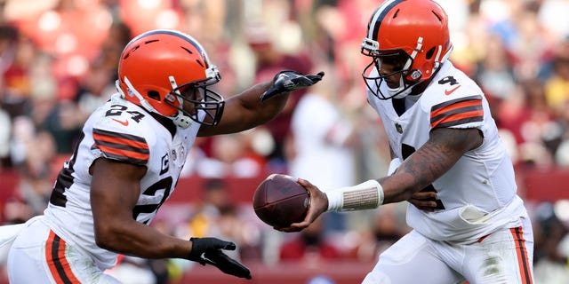 Deshaun Watson #4 of the Cleveland Browns hands the ball over to Nick Chubb #24 of the Cleveland Browns during the third quarter against the Washington Commanders at FedExField on January 1, 2023 in Landover, Maryland.
