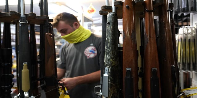 A customer looks at long guns at Coliseum Gun Traders Ltd. in Uniondale, New York.