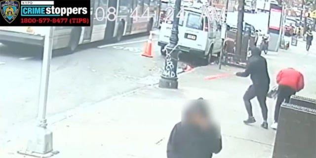 The NYPD released surveillance footage showing a masked suspect clobber another man with a baseball bat on Amsterdam Avenue in Harlem on Dec. 3. 