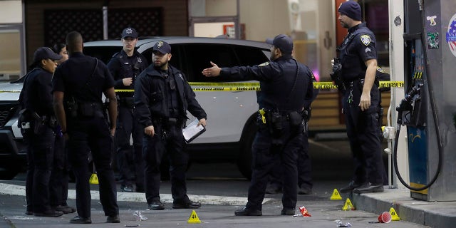 Oakland police investigate a multiple shooting and homicide at the Valero gas station on Seminary Avenue at MacArthur Boulevard in Oakland, California, on Monday, Jan. 23.