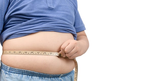 obese child with measuring tape