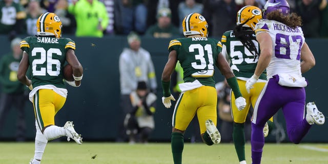 Darnell Savage #26 of the Green Bay Packers returns an interception for a touchdown  during the first quarter against the Minnesota Vikings] at Lambeau Field on January 01, 2023 in Green Bay, Wisconsin.