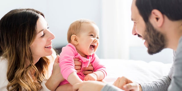 parents laughing with baby