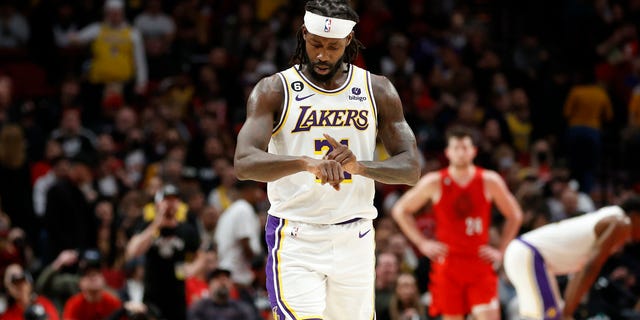 Patrick Beverley #21 of the Los Angeles Lakers imitates Damian Lillard "give me time" Signature gesture during the fourth quarter against the Portland Trail Blazers at the Moda Center on January 22, 2023 in Portland, Oregon.