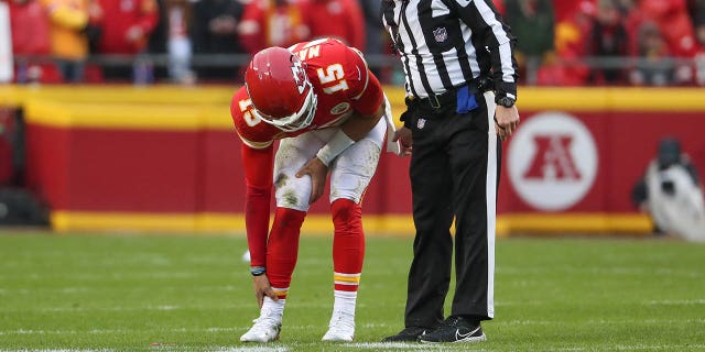 Kansas City Chiefs quarterback Patrick Mahomes (15) holds his ankle in pain in the first quarter of an AFC divisional playoff game against the Jacksonville Jaguars Jan. 21, 2023, at GEHA Field at Arrowhead Stadium in Kansas City, Mo.