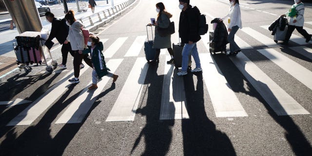 A group of Chinese tourists head to a coronavirus testing center upon arriving at the Incheon International Airport in South Korea, on Jan. 12, 2023.