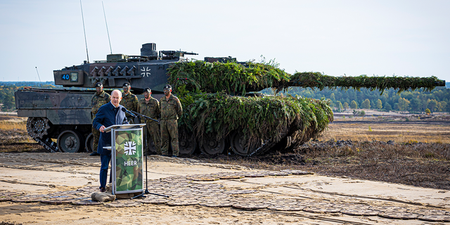 German Chancellor Olaf Scholz speaks to soldiers in front of a Leopard 2 main battle tank after the Army's training and instruction exercise in Ostenholz, Germany, Monday, oct. 17, 2022.