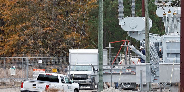 Employees work on equipment at the West End Substation in North Carolina, on Dec. 5, 2022, where a serious attack on critical infrastructure caused many residents to lose power.