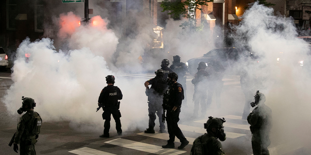 Raleigh Police fire tear gas to disperse a crowd of demonstrators in front of the First Baptist Church at the corner of South Wilmington and East Morgan streets May 31, 2020, in Raleigh, NC