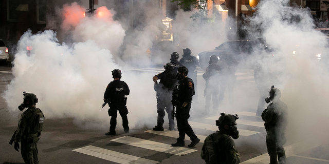 Raleigh Police fire tear gas to disperse a crowd of demonstrators in front of the First Baptist Church at the corner of South Wilmington and East Morgan streets May 31, 2020, in Raleigh, N.C.