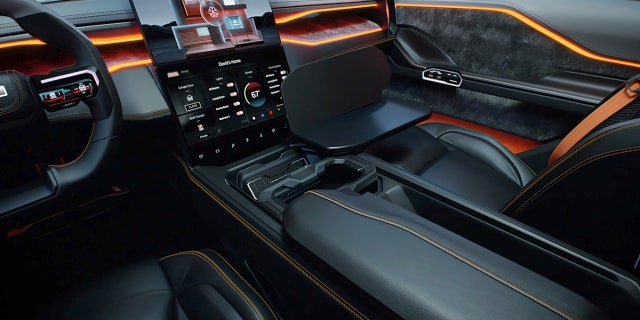 The Revolution's dual screens are repositionable and the front armrests transform into tray tables.