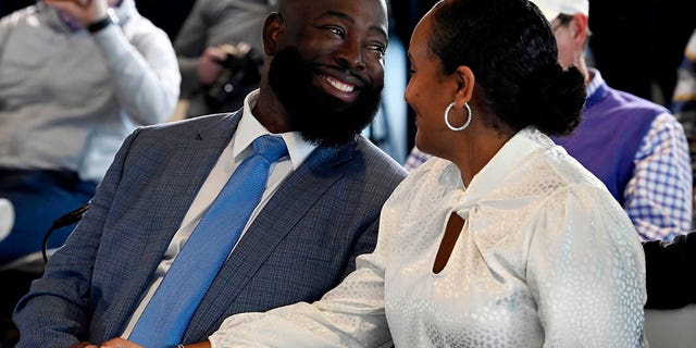 Ran Carthon, new Tennessee Titans NFL football team general manger, smiles with his wife Heaven as they both listen to head coach Mike Vrabel speak during a news conference Friday, Jan. 20, 2023, in Nashville, Tenn. 