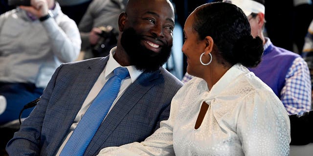 Ran Carthon, new Tennessee Titans NFL football team general manger, smiles with his wife Heaven as they both listen to head coach Mike Vrabel speak during a news conference Friday, Jan. 20, 2023, in Nashville, Tenn. 