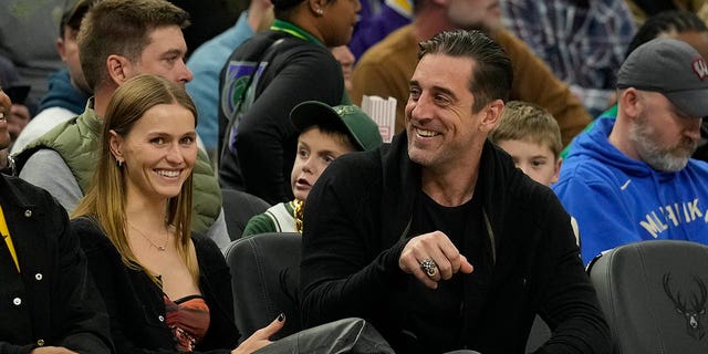 Mallory Edens and Green Bay Packers quarterback Aaron Rodgers watch the second half of a game between the Los Angeles Lakers and Milwaukee Bucks at Fiserv Forum Dec. 2, 2022, in Milwaukee. 