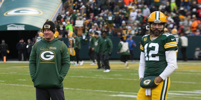 Green Bay Packers offensive coordinator Nathaniel Hackett looks on as quarterback Aaron Rodgers warms up before a game against the Cleveland Browns at Lambeau Field in Green Bay, Wisconsin, on Dec. 25, 2021.