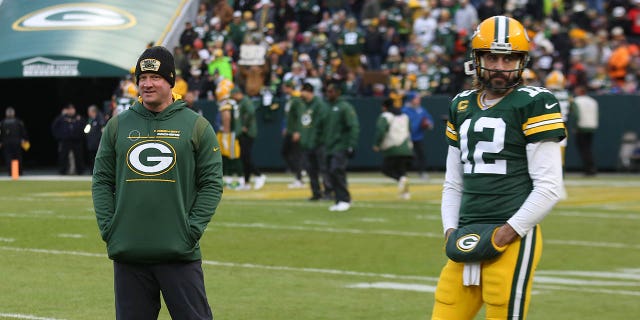 Green Bay Packers offensive coordinator Nathaniel Hackett watches as Green Bay Packers quarterback Aaron Rodgers (12) warms up during a game between the Green Bay Packers and the Cleveland Browns on December 25, 2021 at Lambeau Field in Green Bay, WI.