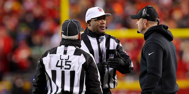 Head coach Zac Taylor of the Cincinnati Bengals, right, talks with referee Ronald Torbert, middle, and line judge Jeff Seeman during the second half of the AFC Championship Game, Jan. 29, 2023, in Kansas City, Missouri.