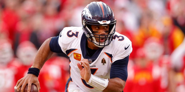 Russell Wilson #3 of the Denver Broncos rushes for a touchdown against the Kansas City Chiefs during the fourth quarter of the game at Arrowhead Stadium on January 01, 2023 in Kansas City, Missouri.