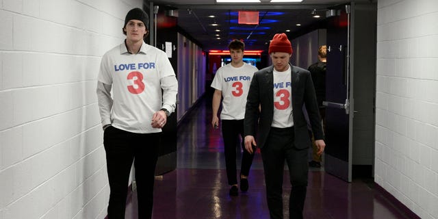 Buffalo Sabers players walk to the locker room as they arrive wearing jerseys in support of Buffalo Bills football player Damar Hamlin before an NHL hockey game against the Washington Capitals, Tuesday, Jan. 3, 2023, in washington. 