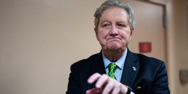 Sen. John Kennedy talks to reporters as he arrives in the Capitol on Wednesday, Jan. 25, 2023.