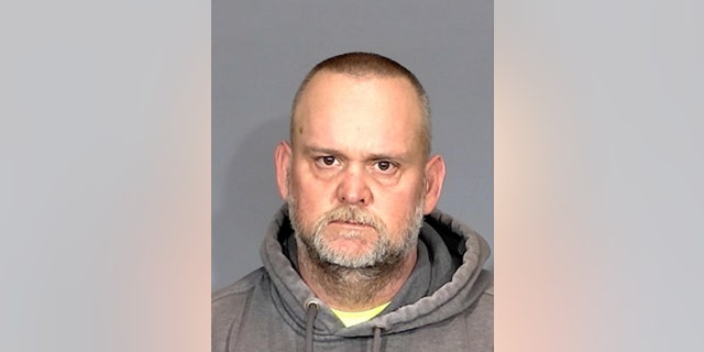 Shane Osborne, 45, of Beech Grove, Indiana, is seen in a mugshot. Osborne faces a charge of felony neglect of a child dependent after a young boy was seen wielding a gun outside an apartment building.