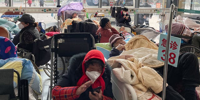 Patients lie in beds in the emergency room of a Shanghai hospital on Jan. 5, 2023, as a COVID outbreak ravages the country.