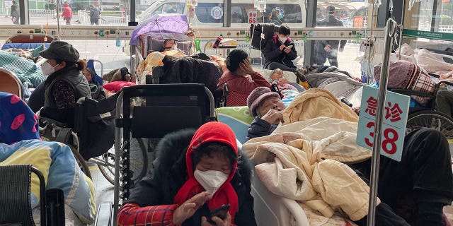 Patients lie in beds in the emergency room of a Shanghai hospital on Jan. 5, 2023, as a COVID outbreak ravages the country.