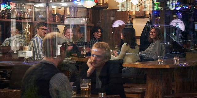 People sit in a bar in Stockholm, Sweden, on March 25, 2020. If the Swedish government abolishes dance licenses, establishments would no longer need approval to organize dance events.