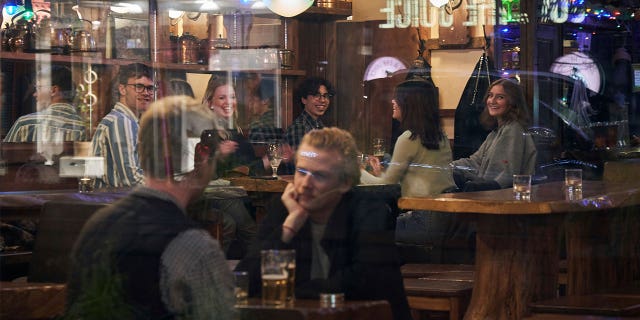 People sit in a bar in Stockholm, Sweden, on March 25, 2020. If the Swedish government abolishes dance licenses, establishments would no longer need approval to organize dance events.