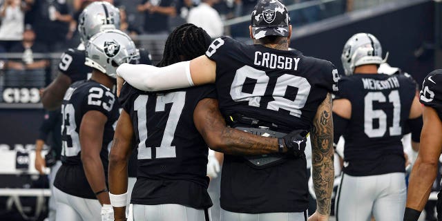 Las Vegas Raiders number 17 Davante Adams and Las Vegas Raiders number 98 Maxx Crosby share a moment as they walk to the sideline before a preseason game against the Minnesota Vikings at Allegiant Stadium on August 14, 2022. in Las Vegas, Nevada.