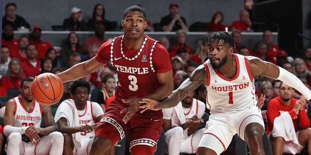 Hysier Miller #3 of the Temple Owls dribbles the end line of the ball around Jamal Shead #1 of the Houston Cougars at the Fertitta Center on January 22, 2023 in Houston, Texas. 