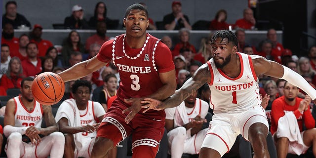 Hysier Miller #3 of the Temple Owls dribbles the ball baseline around Jamal Shead #1 of the Houston Cougars at Fertitta Center on January 22, 2023 in Houston, Texas.