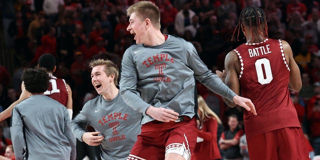The Temple Owls celebrate after defeating the number one ranked Houston Cougars at Fertitta Center on January 22, 2023 in Houston, Texas.