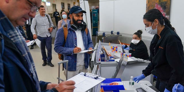 A man returning to his home in New York from Cancun, Mexico, takes an anonymous COVID test for study purposes at the Newark Liberty International Airport in New Jersey on Jan. 4, 2023. 