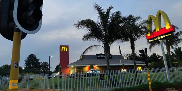 While the traffic lights are out in Johannesburg due to power cuts, a McDonald's restaurant operates on a generator. Critics accuse the current South African president of hypocrisy over his family's ownership and operation of the country's McDonald's franchise.