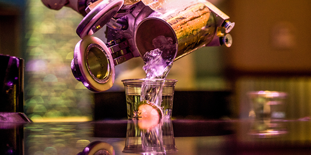 A robot arm pours a cocktail at "Tipsy Robot" in Las Vegas, September 2018.