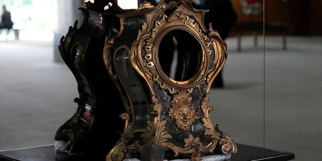 A damaged 17th-century clock, gifted to Portuguese royalty by Louis XIV, stands on display at the presidential office on Jan. 11, 2023, after protestors stormed the building in Brasilia, Brazil.