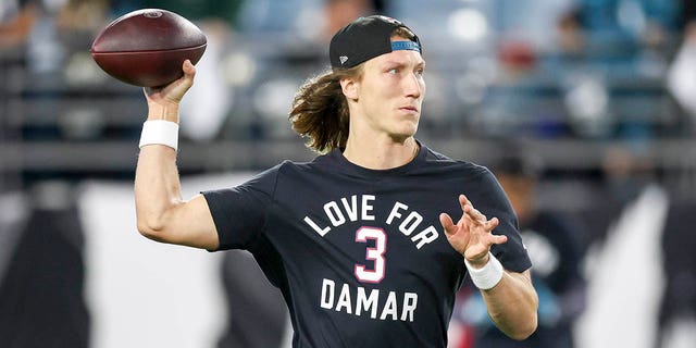 Trevor Lawrence of the Jacksonville Jaguars warms up while wearing a jersey in support of Buffalo Bills safety Damar Hamlin before a game against the Tennessee Titans at TIAA Bank Field on January 7, 2023 in Jacksonville, Florida. 