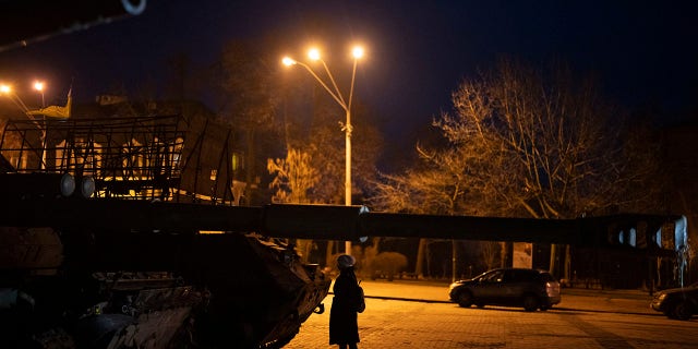 A woman stands in front of a display of destroyed Russian tanks and armored vehicles in downtown Kyiv, Ukraine, Friday, Jan. 20, 2023. (AP Photo/Daniel Cole)