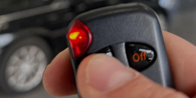 The driver must hold the button on the device's remote while turning the key.