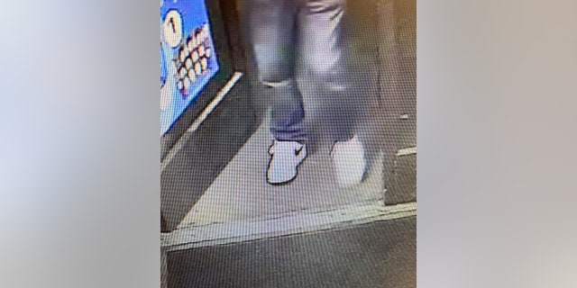 Police released surveillance images of the suspect, who is seen wearing jeans and white Nike sneakers.