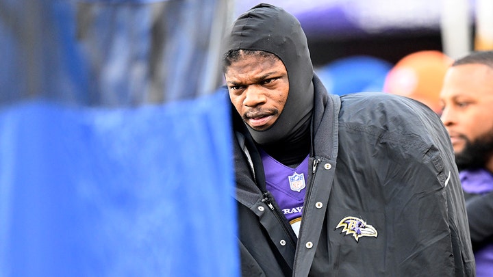 Lamar Jackson smiling on the field.