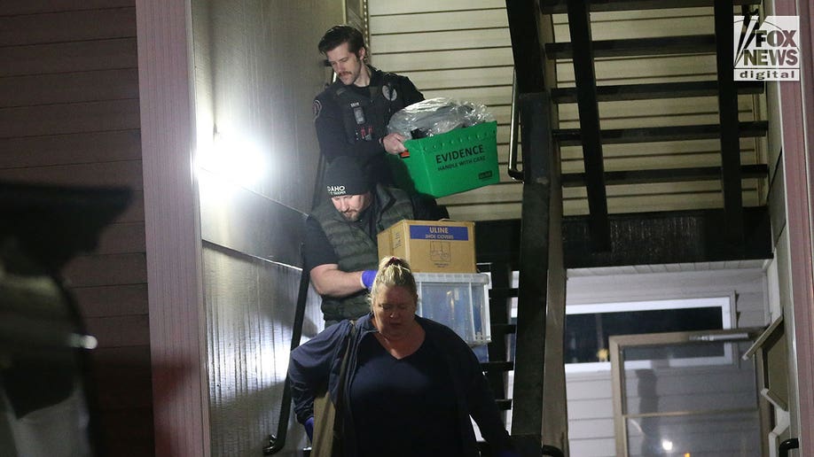 Investigators carry boxes out of Kohberger's Pullman apartment