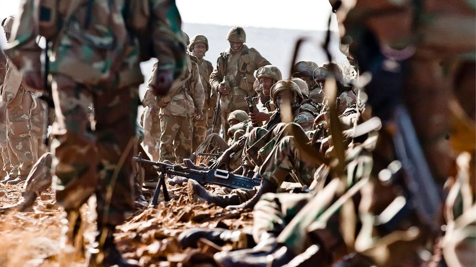 Video shows southern African soldiers throwing bodies on pile of burning rubble in Mozambique