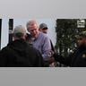 A man is escorted out of a courthouse by police.