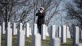 A trumpeter from the U.S. Navy Ceremonial Band plays "Taps" during military funeral honors for U.S. Navy Gunner&rsquo;s Mate 3rd Class Herman Schmidt in Section 70 of Arlington National Cemetery, Arlington, Va., Feb. 23, 2023.